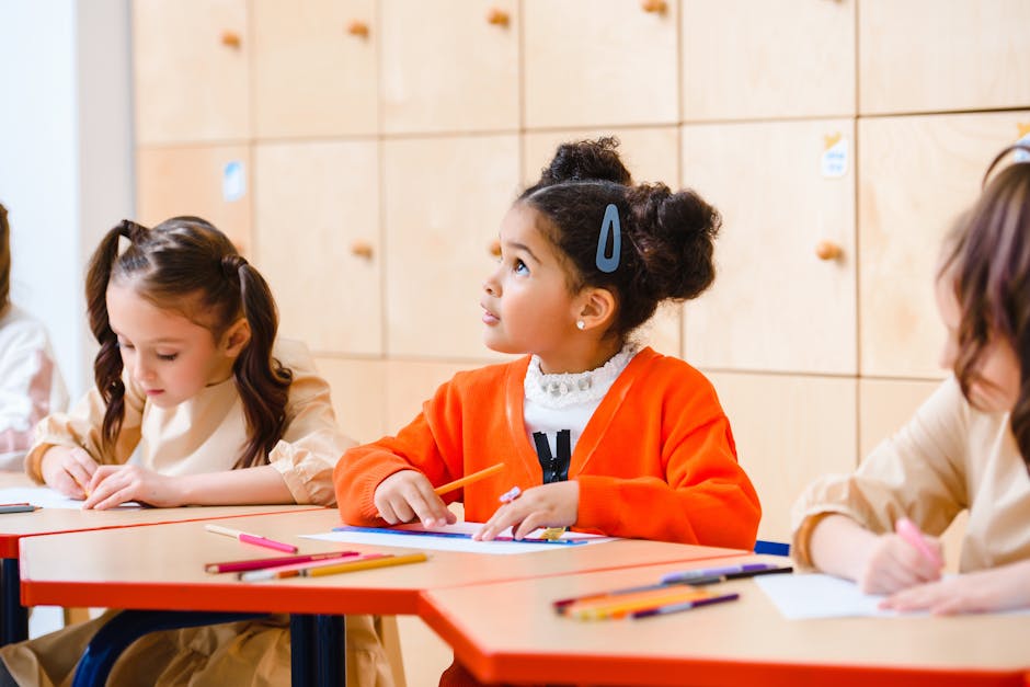 Children engaged in learning activities in a classroom setting.