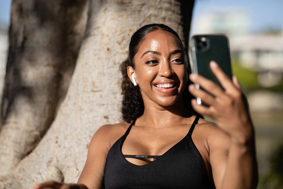 Happy young woman taking a selfie with her smartphone while enjoying the outdoors.